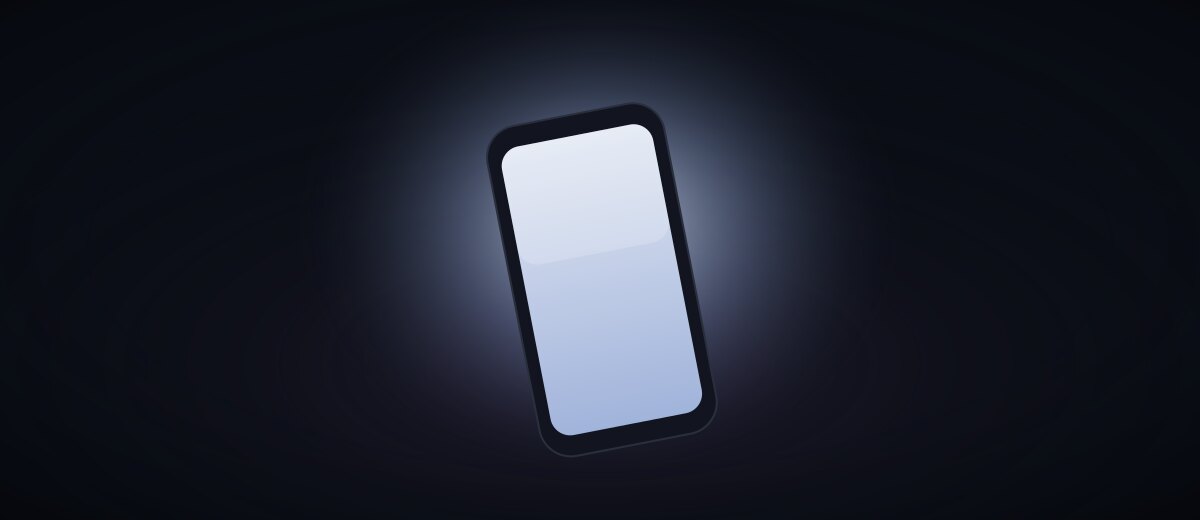 A phone glowing in a dark room at night